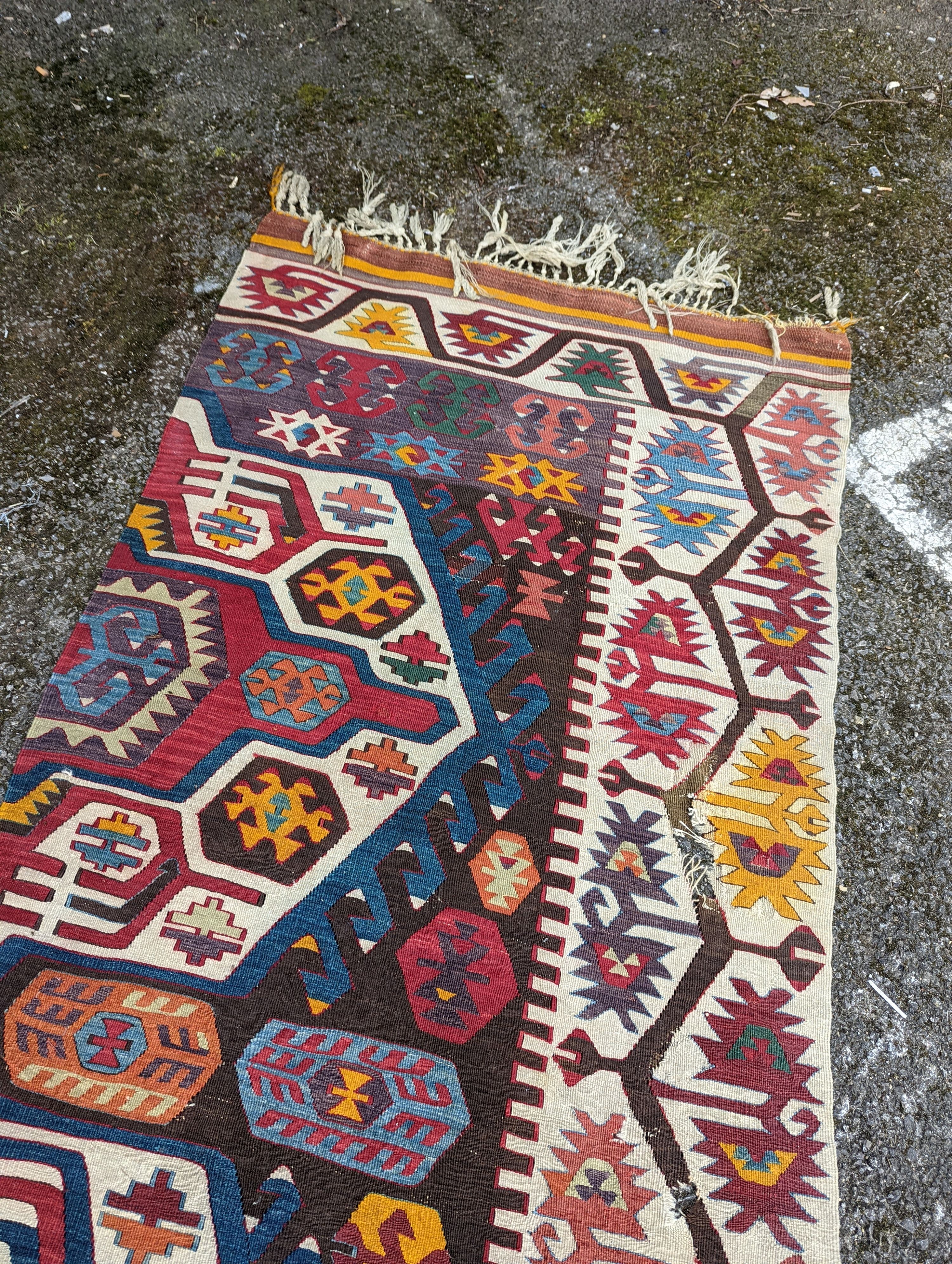 A large Kilim flatweave runner, 400 x 92cm (holed and cut)